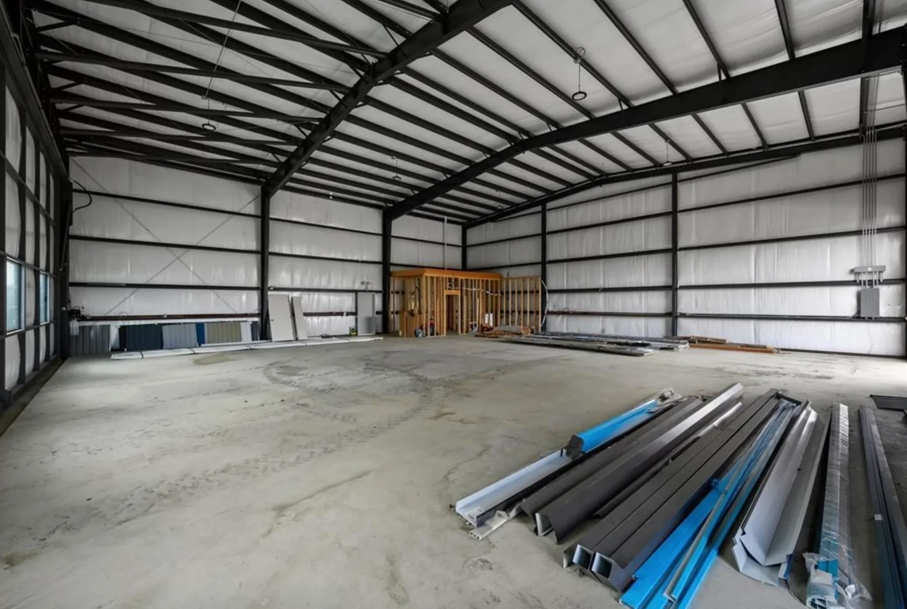 Open steel hangar interior during construction